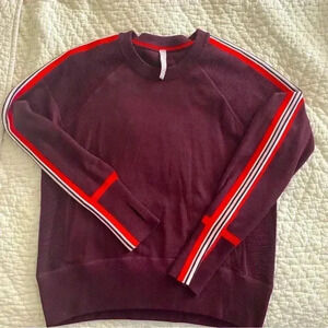 Size m Athleta Burgundy sweater with stripes on the sleeves.